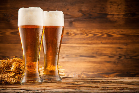 Glasses of beer on wooden planks