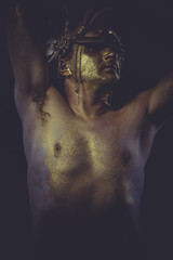 golden bodypaint, man with gold helmet, ancient warrior deity