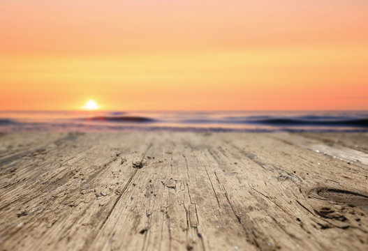 Wooden planks on the beach at sunset