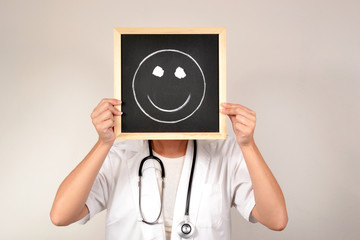 Doctor with smiling face in blackboard