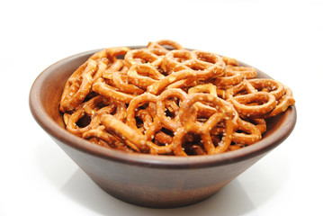 A Brown Wooden Bowl filled with Delicious Pretzels