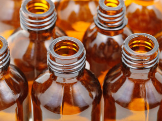 small open brown glass pharmacy bottles close up