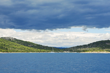 Fototapeta premium coastline of Adriatic Sea under dark blue clouds