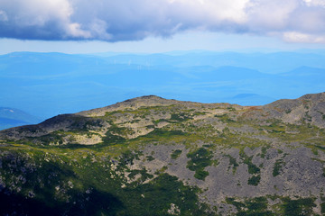 Fototapeta na wymiar Clouds on Top of a Huge Mountain Range