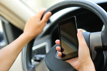 woman driver hands use cellphone driving a car