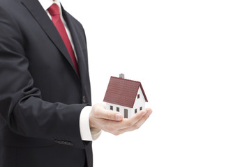 Businessman with house miniature in hand isolated on white