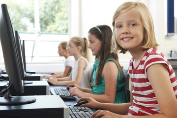 Fototapeta na wymiar Group Of Female Elementary School Children In Computer Class