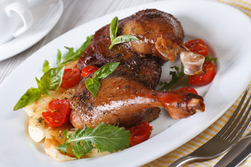 Delicious roasted duck legs with apples and arugula horizontal