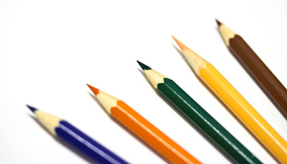 Colour pencils on white background close up