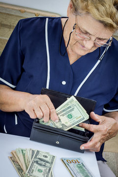 Pensioner holding wallet with money
