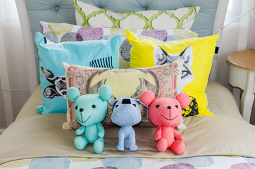 dolls on colorful kid bed