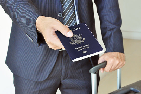 Businessman giving U.S. passport