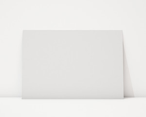 blank horizontal poster on the white wall and the floor