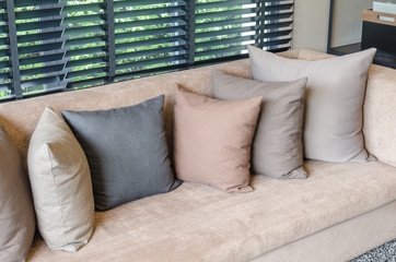 pillows on brown sofa