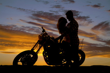 Fototapeta na wymiar silhouette couple kiss on motorcycle