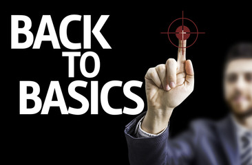 Business man pointing the text: Back to Basic