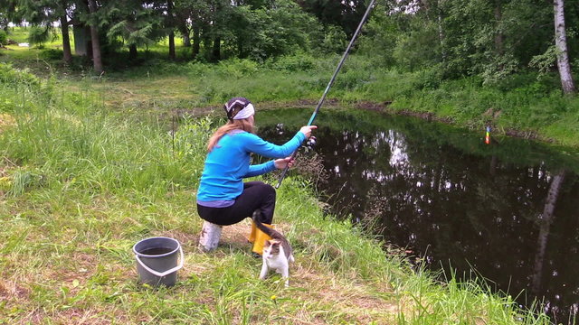 gir angler fishing in rural pond, hungry cat wait for fish.