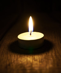 Obraz na płótnie Canvas Burning candle. On wooden background.