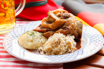 eisbein with braised cabbage, potato and beer