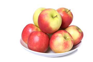 a dish full of fresh apples isolated on a white background