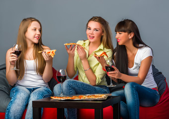 Three girls with wine and pizza