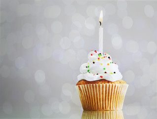 Tasty cupcake on bright background