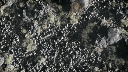 Aerial of grey rock mountain landscape with dry vegetation.