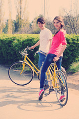 Fototapeta premium Young couple with bicycles in park