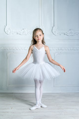 A little adorable young ballerina in a playful mood in the inter © jutaphoto