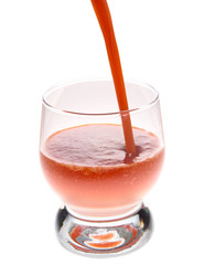 The juice is poured into a glass