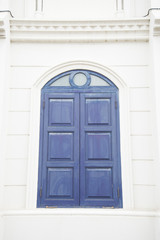 blue window on a white wall