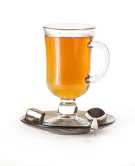 Cup of tea with spoon and candy