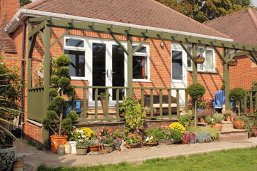 A colourful veranda on a bungalow with flowers and plants