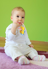 Young cute baby sitting on floor