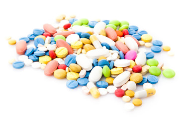 Fototapeta na wymiar Pile of various colorful pills isolated on white
