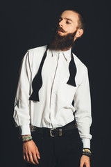 Young handsome man in white shirt on black background