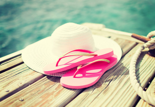 close up of hat and slippers at seaside