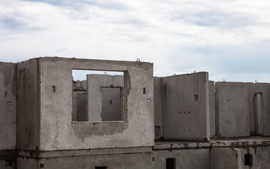 Unfinished grey concrete building in the construction site