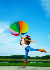 Multicolor umbrella woman jump to sky