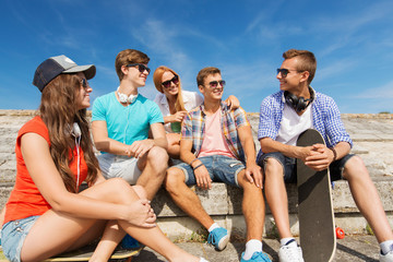 group of smiling friends sitting on city street