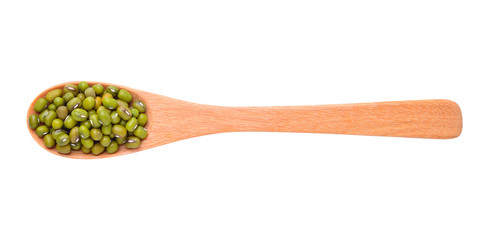 Raw mung beans in wooden spoon over white background