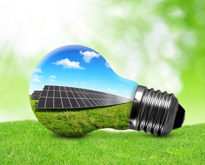 Solar panels in light bulb. Green energy concept.