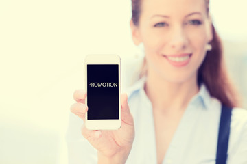 Businesswoman showing smart phone with promotion sign on screen