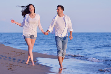 Fototapeta premium young couple on beach have fun