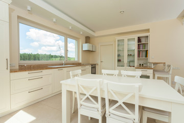 Contemporary kitchen with big white table