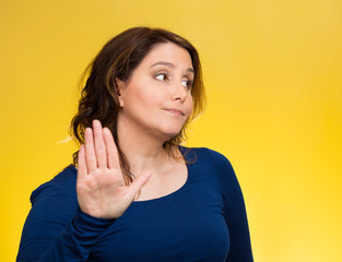 Grumpy woman with bad attitude, giving talk to my hand gesture