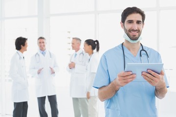 Smiling doctor with a tablet