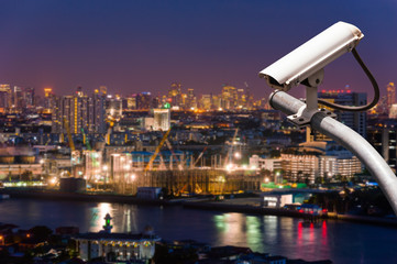 Fototapeta na wymiar CCTV or surveillance with Blurring City in background