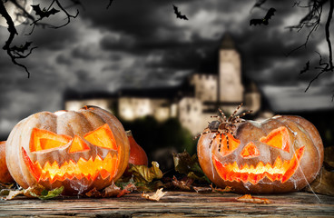 Halloween pumpkins on wood with dark background
