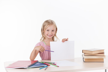 little girl studying literature and smiling.